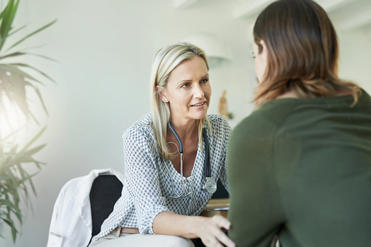 a nurse listening intently to her patient