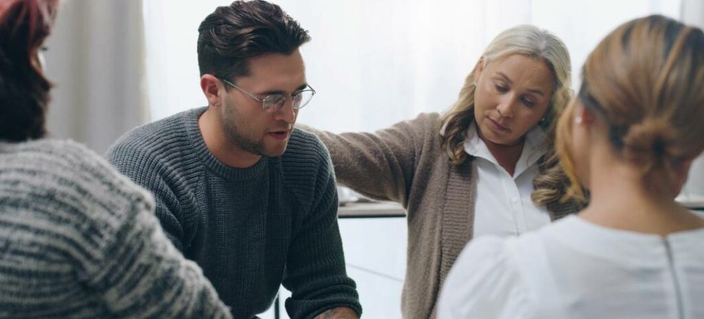 Man taking part in a group therapy session at rehabilitation